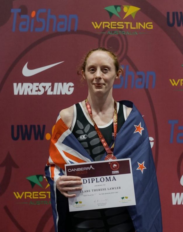 Clare looking happy with NZ flag and medal